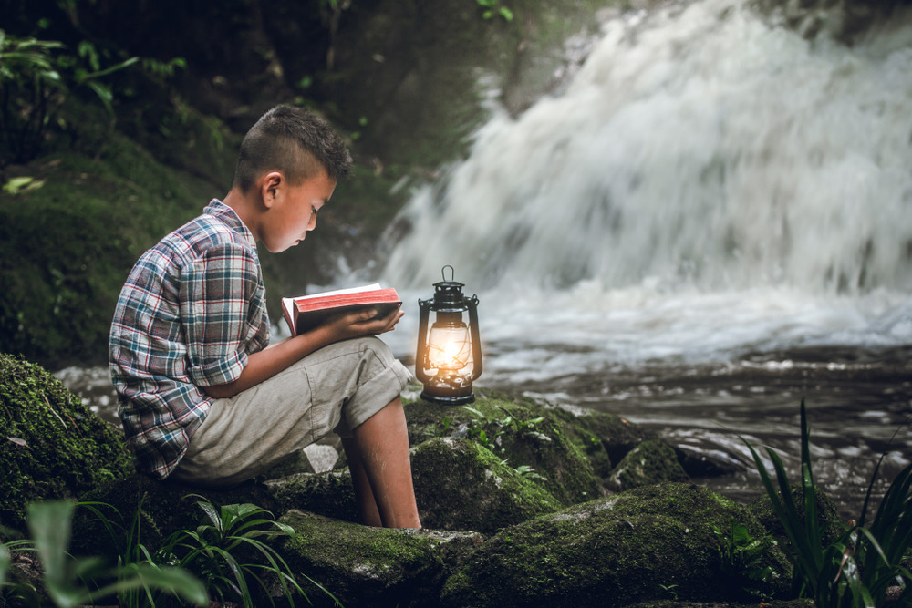 A young person reading an open Bible