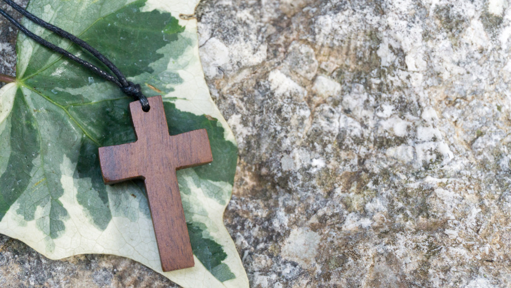 A cross against soft green light