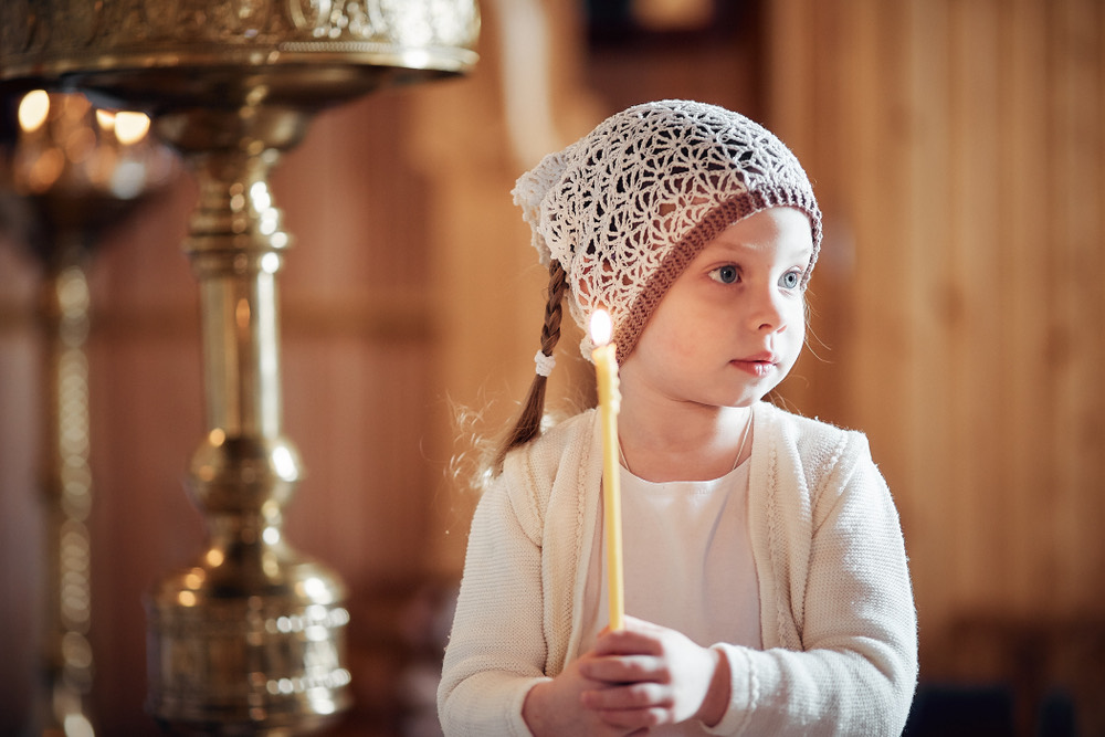A child venerating an icon in an Orthodox church